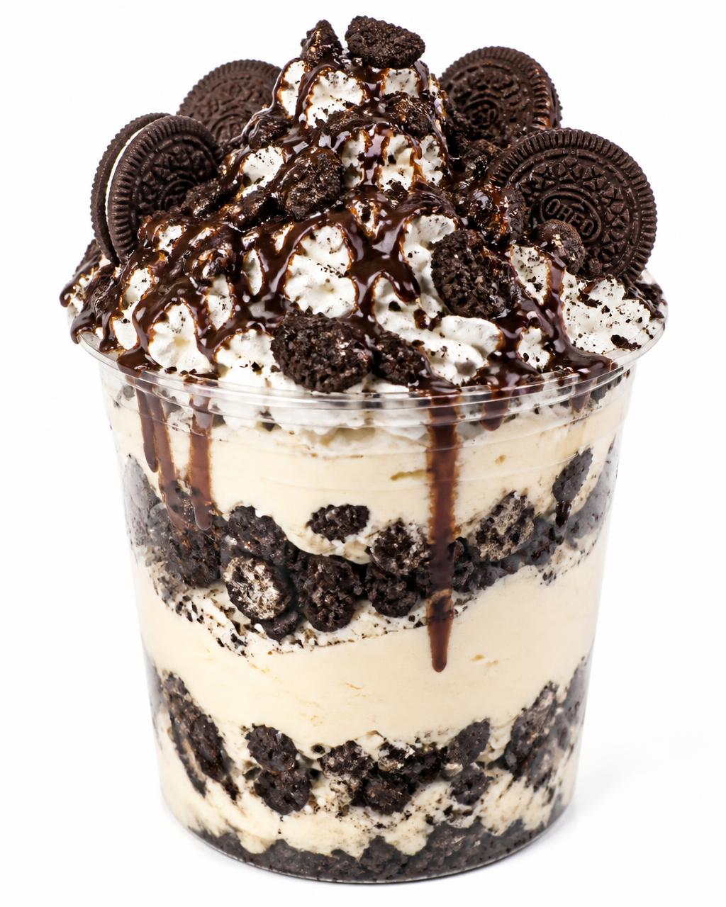 Oversized 32 ounce clear cup layered with cheesecake, cookie crumbles, whipped topping and chocolate drizzle